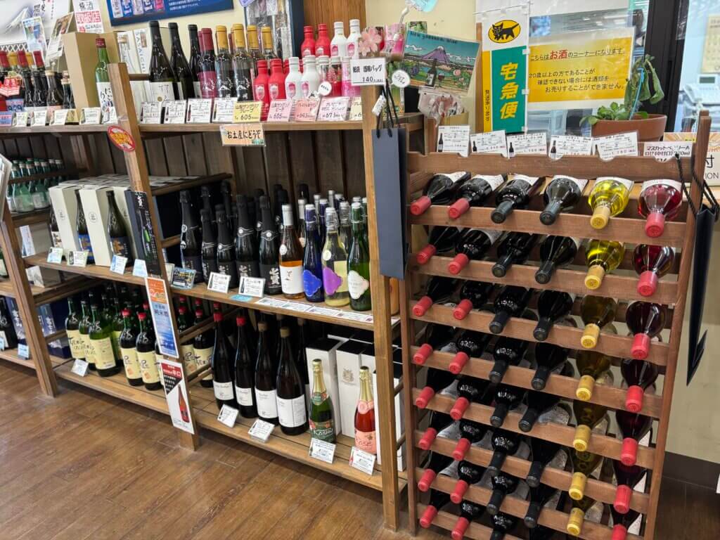 山梨ワインの棚に甲州・マスカットベーリーA・スパークリングなど多種類のワインが並ぶ様子